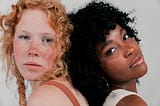 Close-up two multiethnic woman’s face looking at camera, low porosity hair, kinky curly hair, red hair, curly red hair, 4c hair, 4b hair, 3a hair, 3b hair, 2c hair, low porosity hair test, curly hair, kinky hair, wavy hair