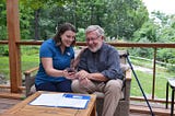 home care aide shares a photo with elderly client