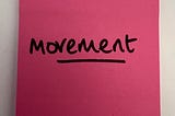 image of a pink post it note saying movement