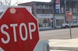 stop sign in front of US Post Office building