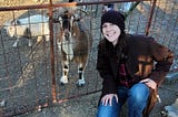 Rachelle is pictured with goats at a local family farm in Texas
