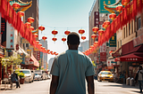 A lone man of African descent is walking on a Chinese street, where vibrant colors blend harmoniously with the surroundings, capturing the essence of cultural diversity and individuality. The bustling street is filled with traditional architecture and modern signs, which creates a juxtaposition of past and present. The man's confident stride embodies resilience and the assertion of his identity. A sense of mystery and allure permeates the air, drawing the viewer into the scene.