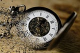 A pocket watch decomposing and blowing away.
