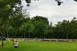 A lady sitting on the lawn looking at the distance