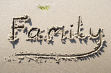 “Family” drawn in the sand.