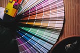 A multi colored umbrella on brown wooden table