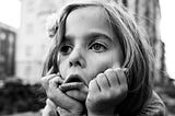 A fed-up looking little girl in black and white