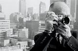 Henri Cartier-Bresson taking a picture from a rooftop.