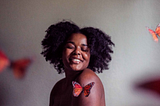 Photo by Jessica Felicio on Unsplash | Black girl surrounded by butterflies