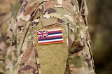Member wears OCP uniform with state of Hawaii flag