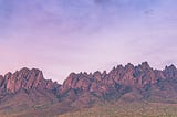 color photo of New Mexico Mountains — maybe sunset with a purple overall hue