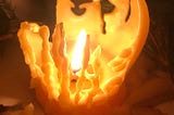 Candle flame inside melted candle