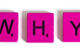 Pink Scrabble tiles spelling out why