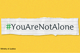 A piece of paper ripped from a noteback with the hashtag ‘YouAreNotAlone’.