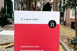A photo of the book Expressive Design Systems in front of a street scene