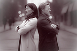 two people upset and angry standing back to bacl with their arms crossed, conflict, rupture, repair, relationship