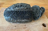 Black bread with black sesame seeds on top.