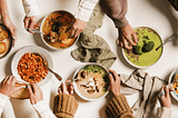 Four bowls full of coloured, vegan soups