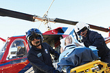 Picture of people removing a patient from a medical helicopter.