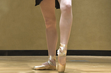 ballet dancer’s legs with pointe shoes