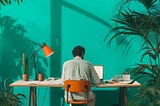 A man sitting at a desk working on his laptop
