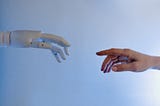 Robot hand reaching out to touch the pointer finger of a human hand