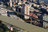 Photo of steel structure high above a city.