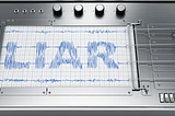 Lie detector machine that has the word liar scribbled on the paper that feeds from the machine when in use