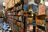 Four photos of a bookstore with full shelves of books, zines and more.