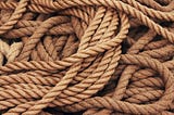 Image of tangled boat mooring ropes as a representation of something difficult to solve.