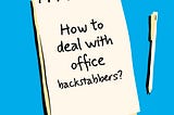 A image designed by the author (Shark in the Suit) of a notepad and pen. The notepad has a message; “How To Deal With Office Backstabbers?”