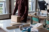 Man processing and packing orders to ship