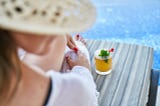 Woman drinking cocktail at the beach