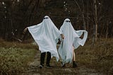 A couple dressed as ghosts.
