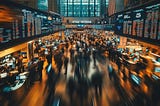Wide view of the New York Stock Exchange packed with motion-blurred traders, towering LED tickers and desk-mounted screens streaming real-time prices — capturing the frenetic atmosphere of AI-driven predictive trading.