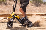 A closer look at the Splach Transformer electric scooter on a dirt road.