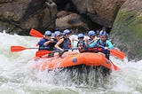 A team in the boat during white water rafting