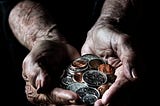 Elderly woman’s hands with change