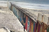 The border wall extends into the Pacific Ocean