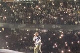 Kendrick Lamar sings at the Grand National Tour.