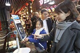 A woman pays for her purchase by using Alipay’s ‘Dragonfly’​, a facial recognition payment system. Credit: news.cgtn.com.