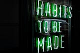 Neon sign reads Habits to be made | Image by Unsplash | Drew Beamer@drew_beamer