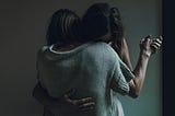 Two women hugging