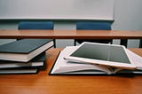 A classroom desk with books and an iPad signifying futurism