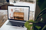 Image of a laptop featuring a web page about an interior designer and stylist.