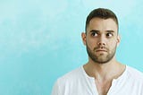 Man in a white shirt looking confused