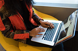 A woman working on a laptop.