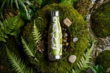 A sustainable water bottle with a nature-inspired background by AI Artz