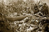 Image of the massacre of Bud Dajo, Jolo Island, Philippines with US soldiers posing beside a mass grave of decaying victims.