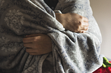 a woman covered in a blanket of grief